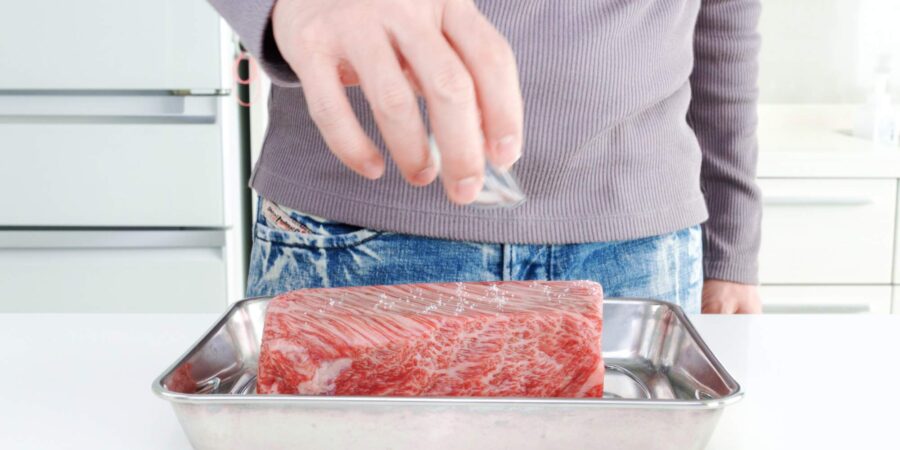 Sprinkling wagyu beef with salt.