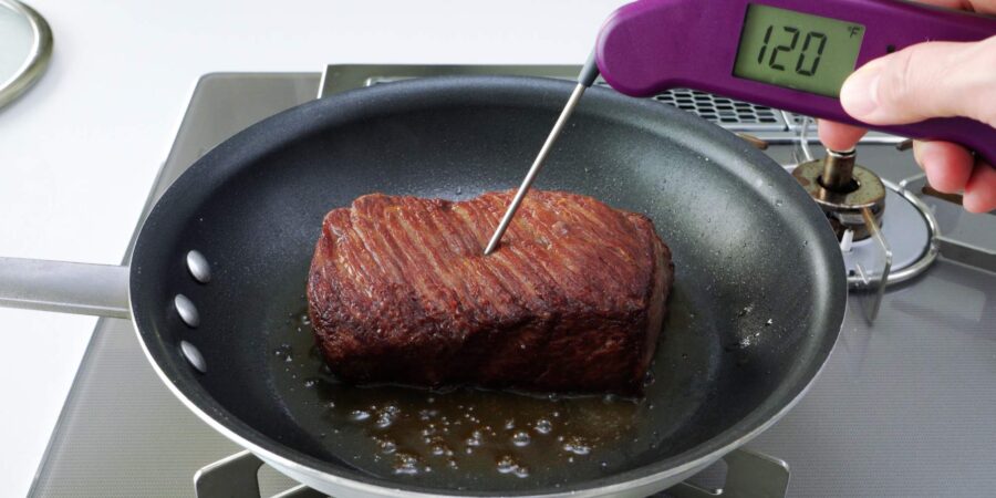 Checking roast beef with an instant read thermometer.