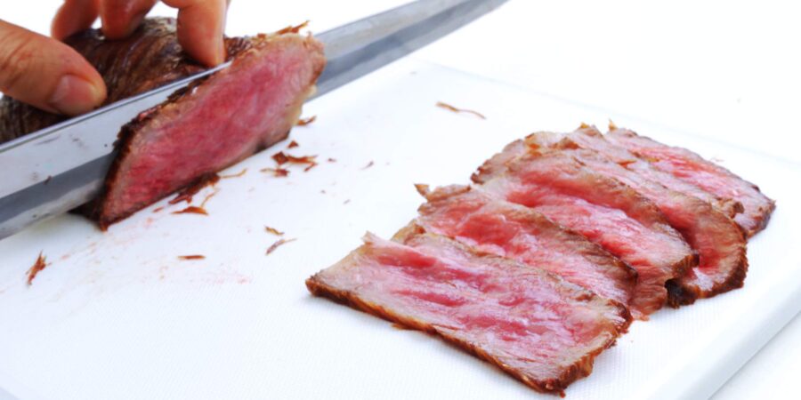 Slicing rare wagyu roast beef.