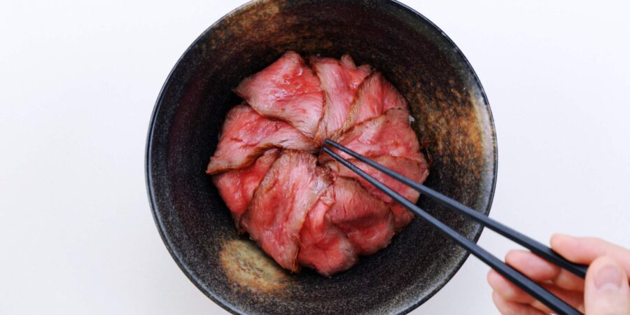 Thin slices of roast beef in a bowl.