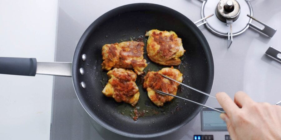 Flipping mango chicken over.