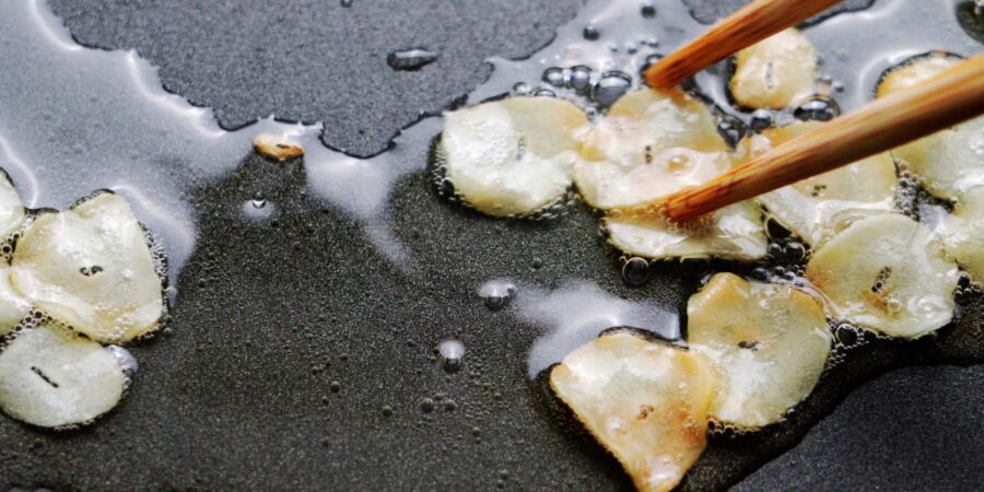 Crispy browned garlic chips in oil.