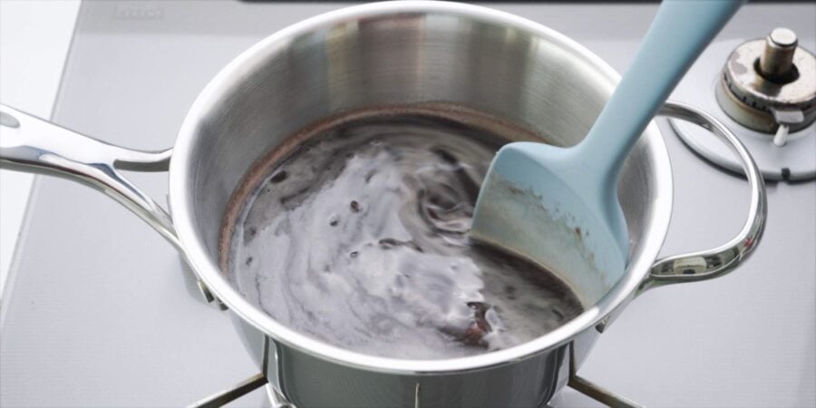 Stirring red bean soup with a spatula.