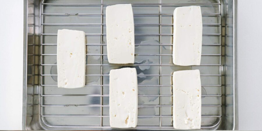 Draining tofu on a wire rack.
