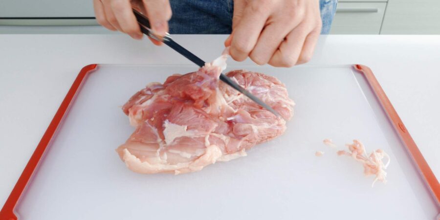Trimming chicken leg.