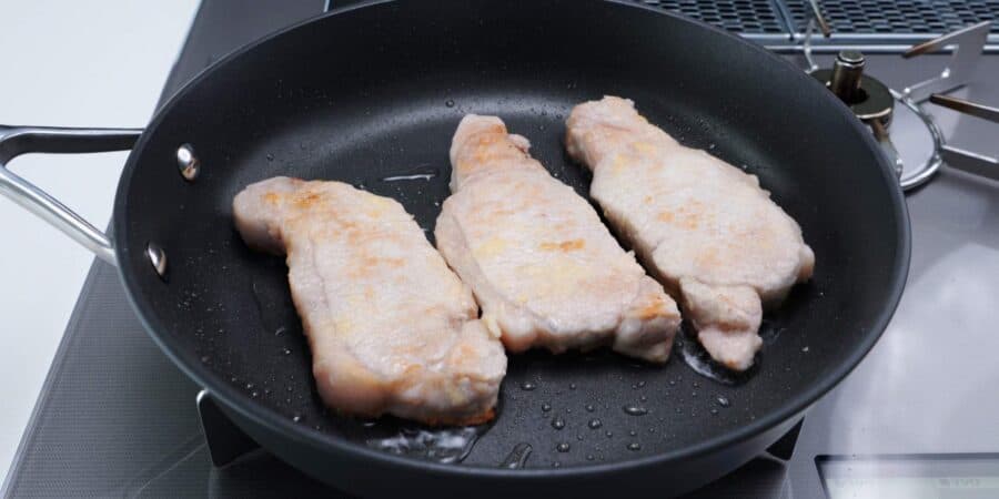 Ginger pork chops in a frying pan.