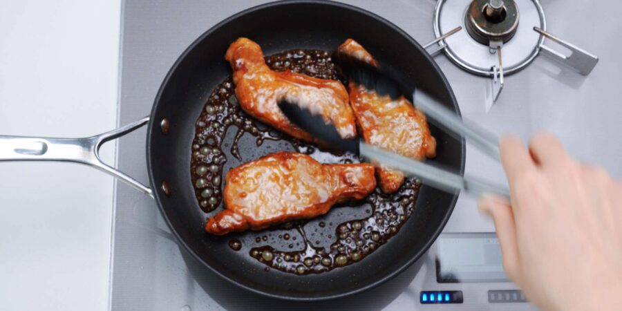 Glazing shogayaki in a frying pan.