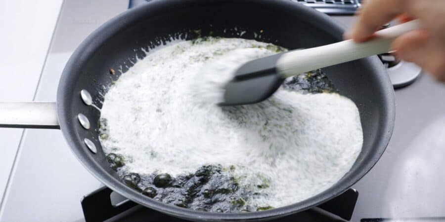 Stirring cream into nori for Japanese pasta.