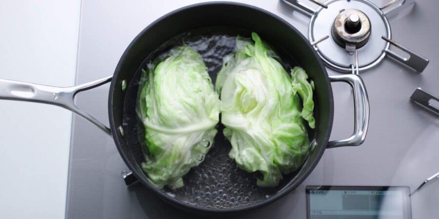 Boiling a head of cabbage for making Japanese potstickers.