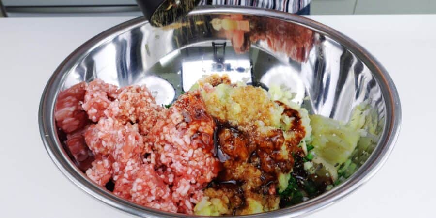 Ingredients for pork and cabbage gyoza in a large bowl.