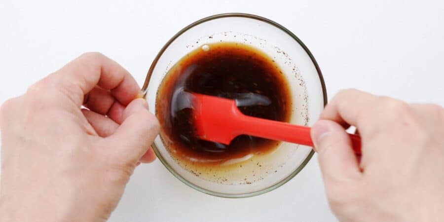 Mixing together oyster sauce, sake, and black pepper to make yaki udon sauce.