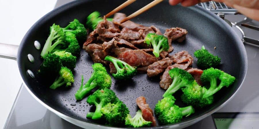 Stir frying broccoli with beef.