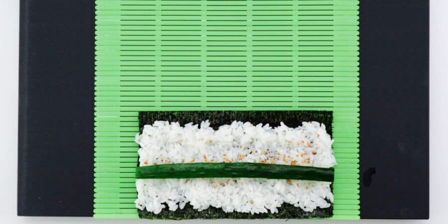 Cucumber and sushi rice and a nori sheet.