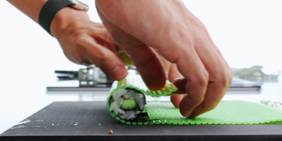 Rolling sushi with a sushi mat.