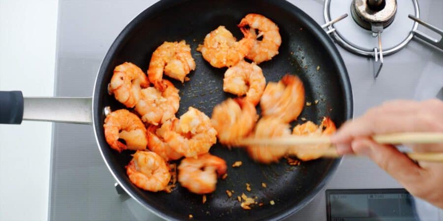 Shrimp and garlic in a pan.