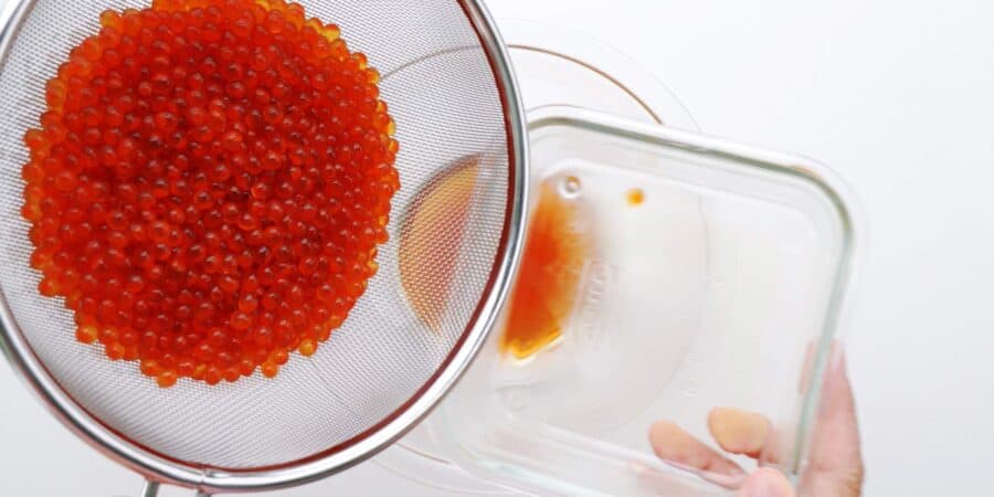 Draining cured ikura.