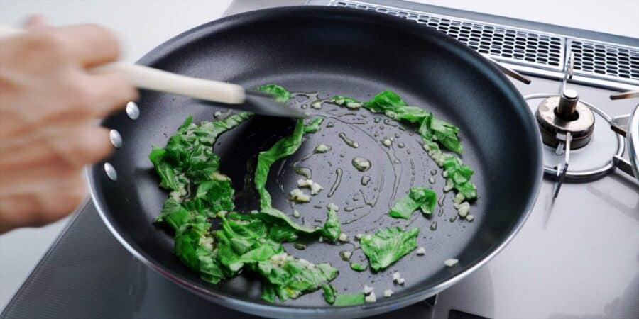 Sautéing garlic and basil for pomodoro sauce.
