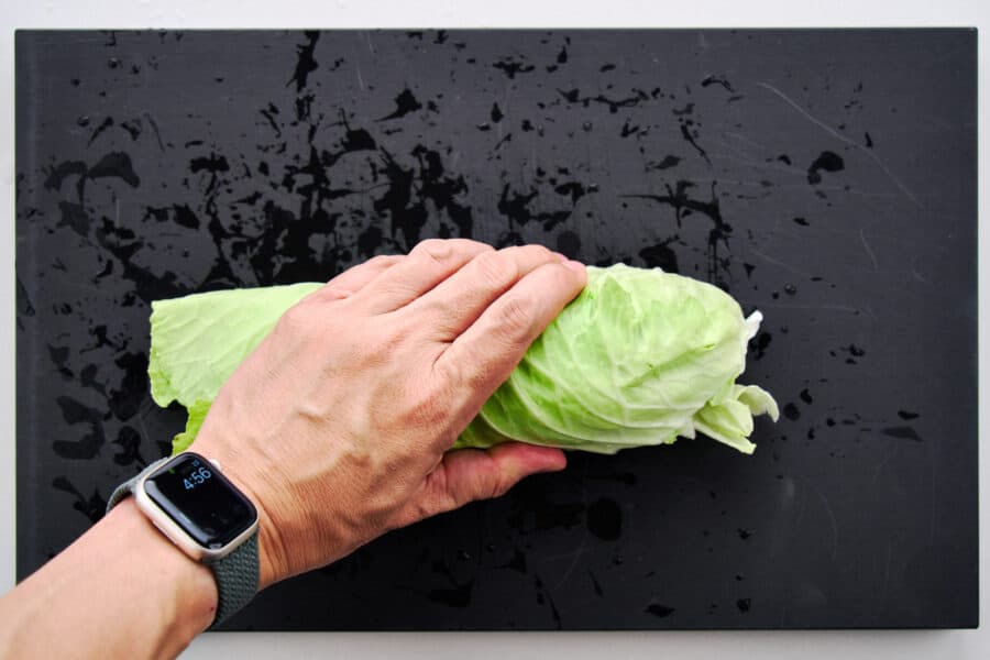 Rolled cabbage leaves ready to shred with a knife to make a salad.