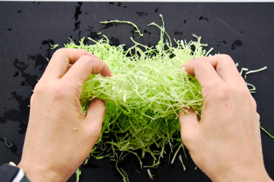 Fluffing up shredded cabbage.