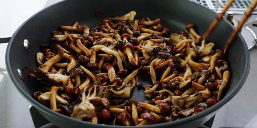 Sautéing a medley of Japanese mushrooms in olive oil.