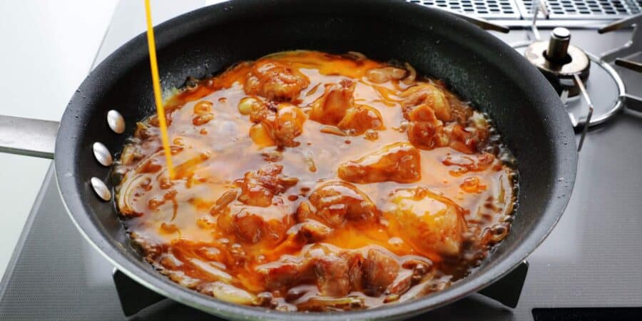 Egg added to a pan of oyakodon.