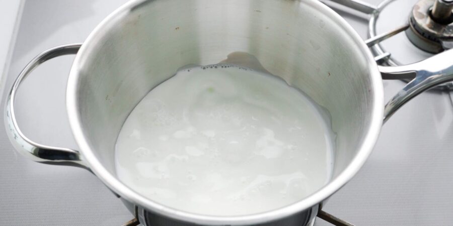 Heating milk in a pot.