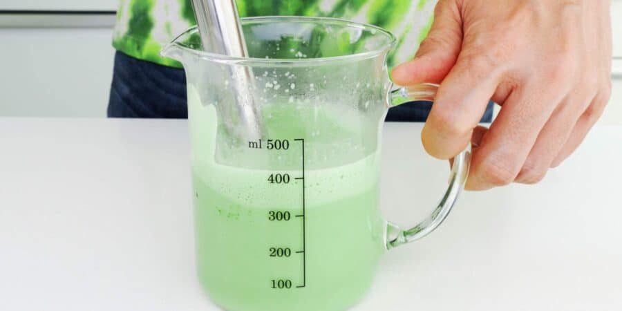 Whisking matcha latte with an immersion blender.