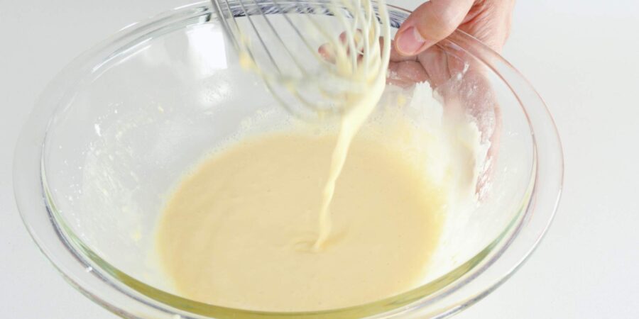 Whisk and bowl of fluffy tempura batter.
