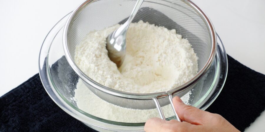 Sifting flour with baking soda and salt for Sata Andagi.