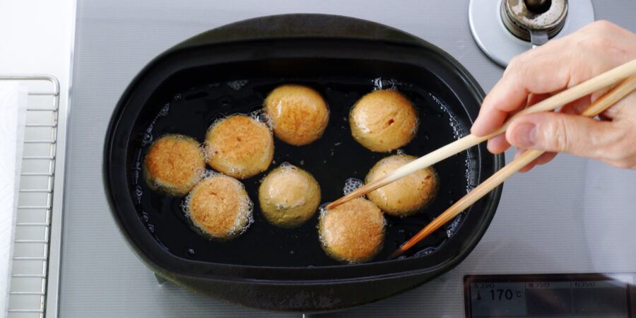 Frying Okinawan donuts in oil.