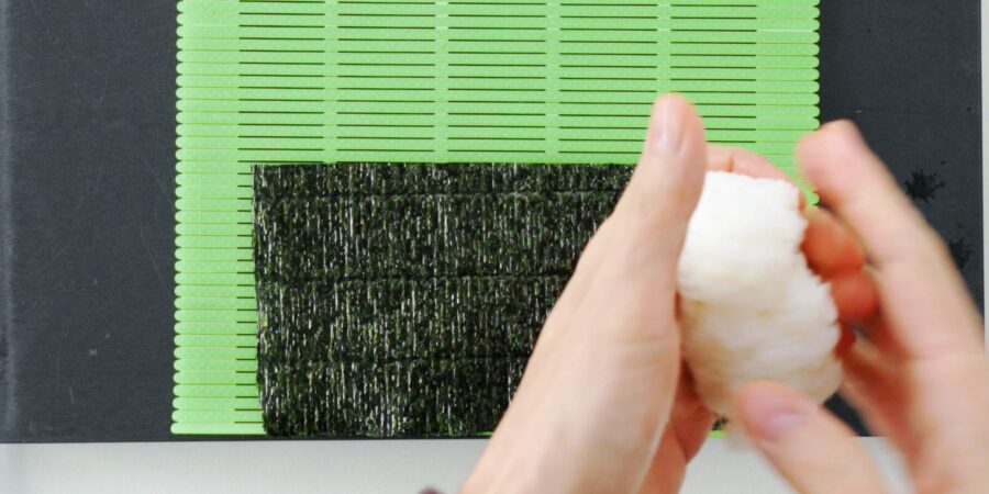 Grabbing a handful of sushi rice.