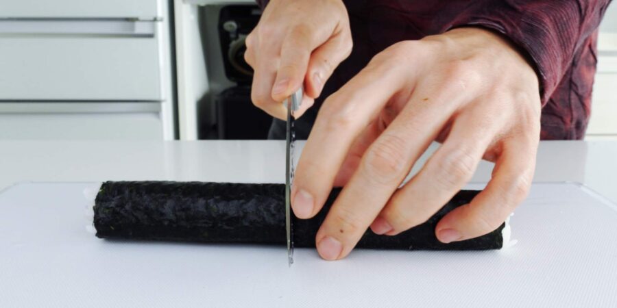 Cutting a sushi roll in half.