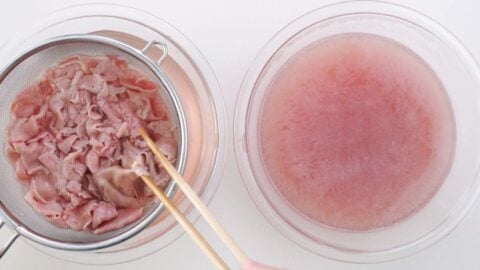 Chilling blanched wagyu beef in cold water.