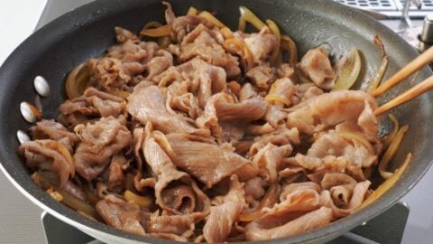 Coating A5 wagyu beef with gyudon sauce.