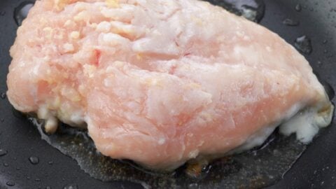 Pan-frying chicken breast.